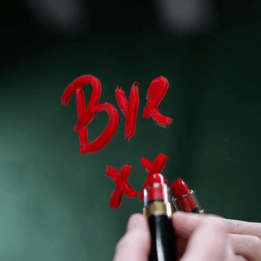 'bye xx' written in lipstick on a mirror